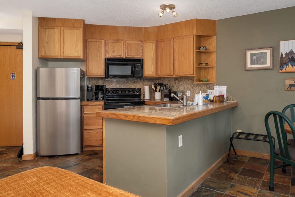 Enjoy a fully functional kitchen with polished countertop.