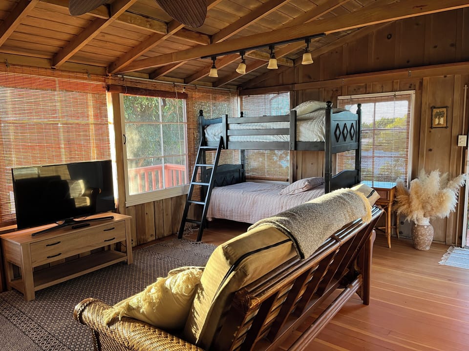 Upstairs of carriage house living space with additional TV and bunk beds