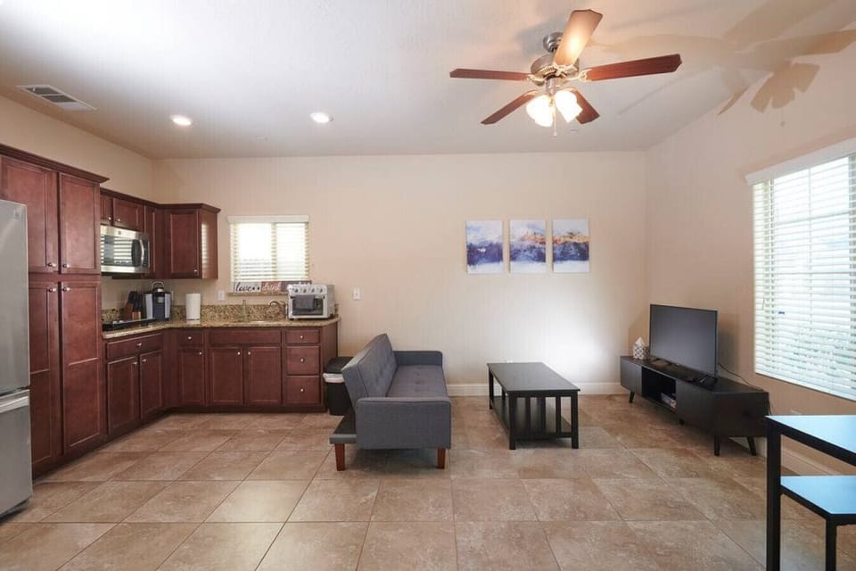 Open space- Kitchen, living room with 55" TV, Roku, dining table, and chair.