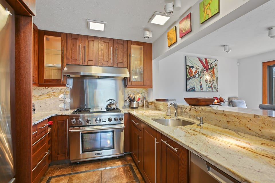 High-end chef kitchen with thremador gas range and granite counter tops