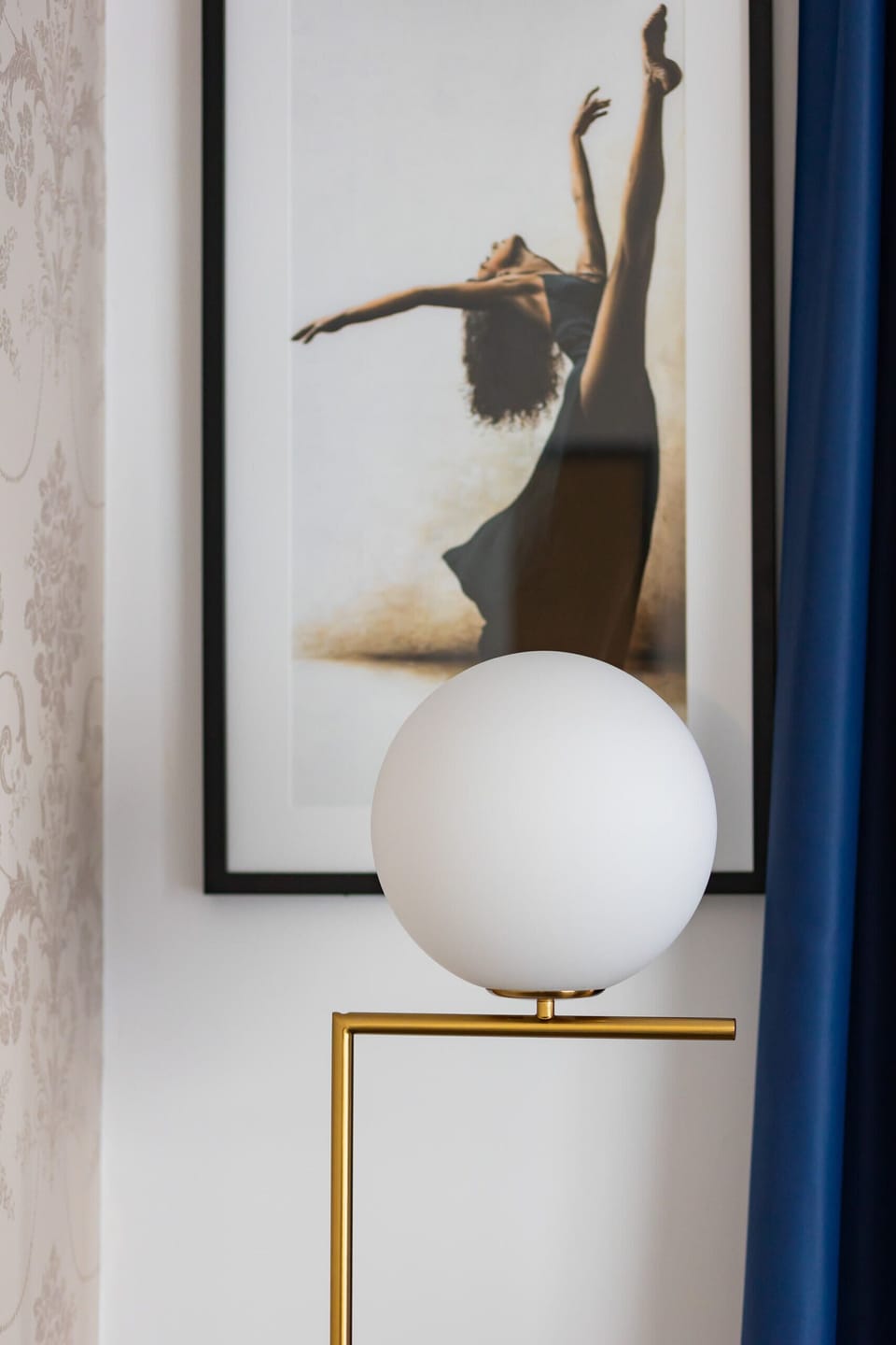 A close-up of modern decor featuring a small artistic sculpture and framed wall art.
