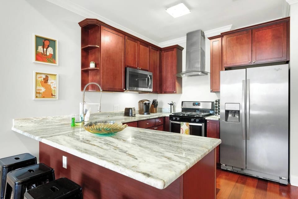 Fully equipped kitchen with modern appliances and granite countertops.