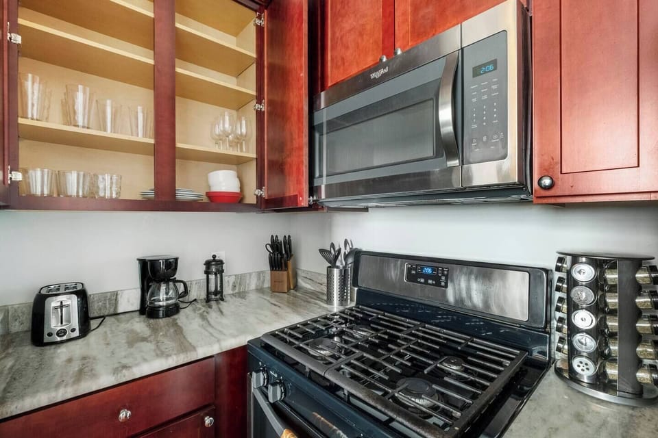 Kitchen workspace with gas range, granite countertops, and ample cabinetry keeping everything organized.