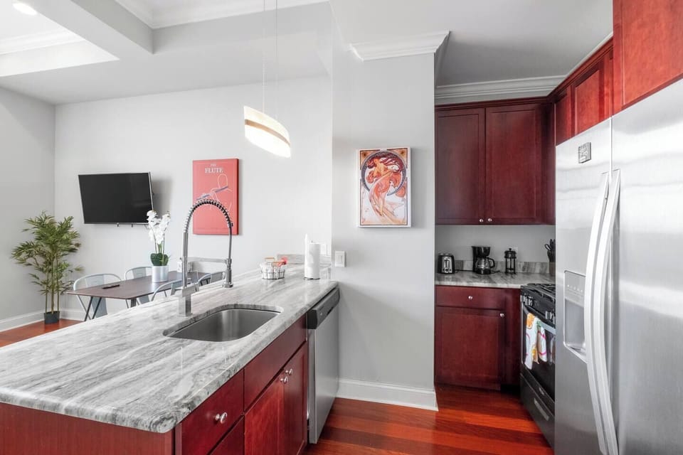 Fully-equipped kitchen with cherry wood cabinets, stainless appliances, and granite counters ideal for preparing home-cooked meals.