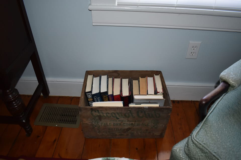 Selection of books in an antique soda box