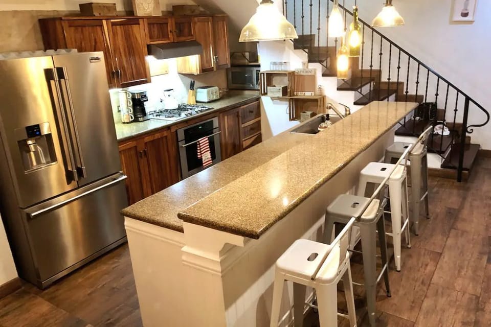 Granite countertops and raised breakfast bar