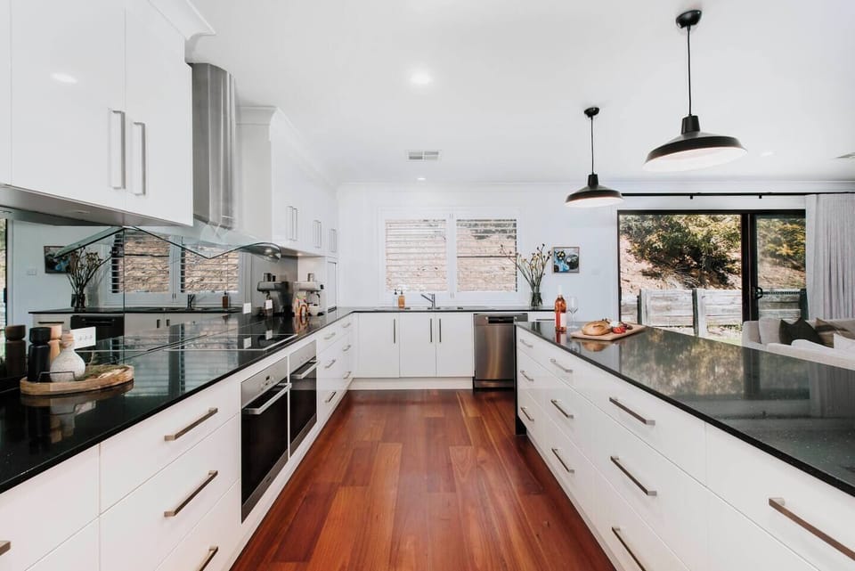 The gourmet kitchen is designed around a central island for preparing meals or enjoying slow mornings at home.
