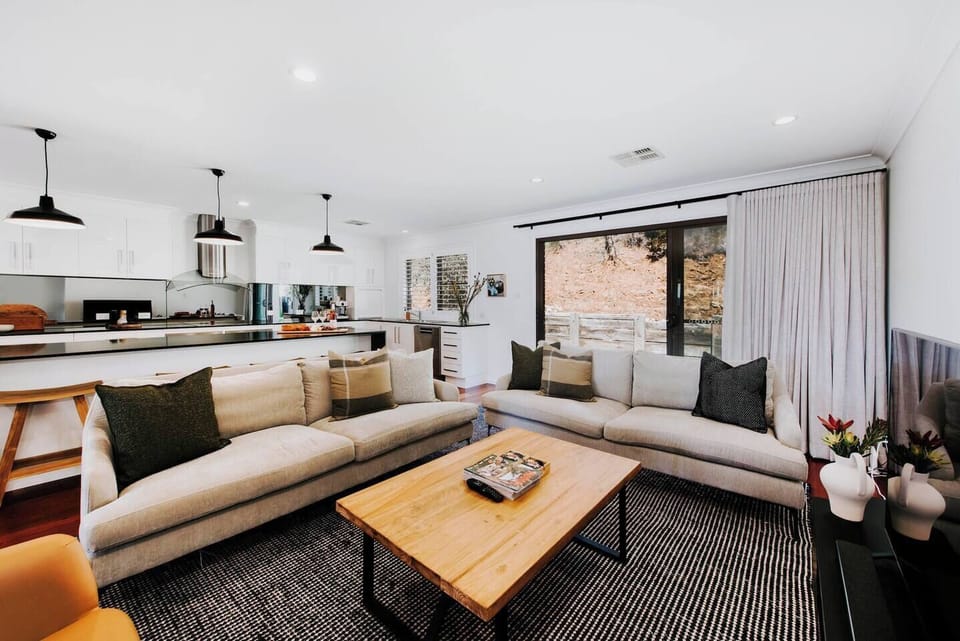 Kick back in the lounge room with plush sofa seating and a central TV.

