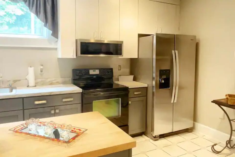 The fully stocked and renovated kitchen has 2 refrigerators and washer/dryer.
