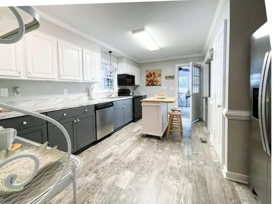 The fully stocked and renovated kitchen spills out to the sun room/wine bar. 