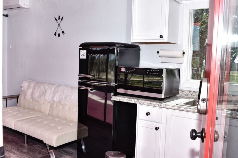 Modern kitchenette with fridge, microwave, and all the basics you’ll need.