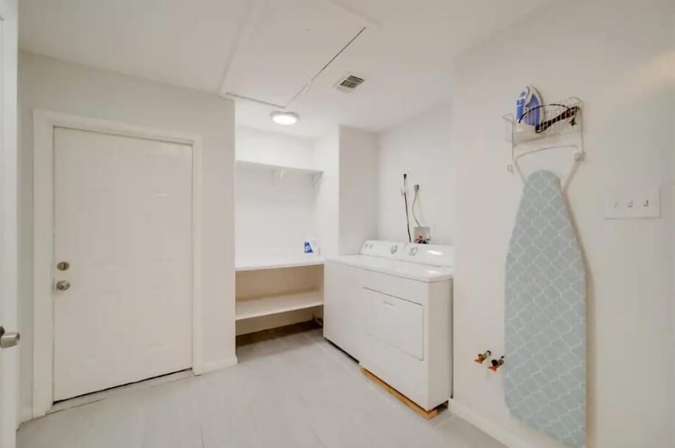 Laundry Room with washer, dryer, iron, and storage shelves. Stay fresh all trip long!