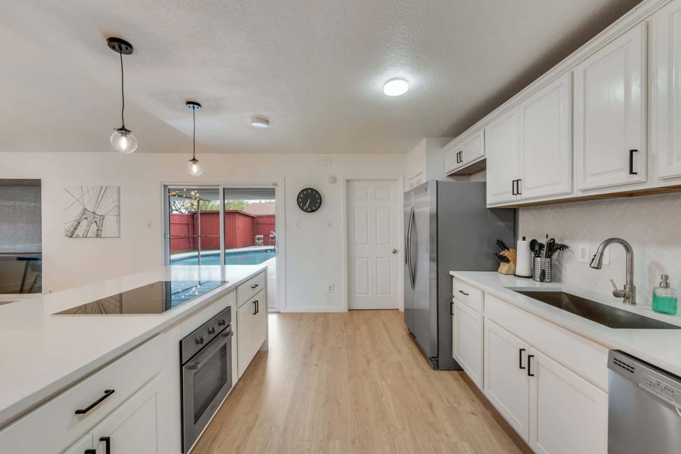 Fully equipped kitchen with pool views, tons of counter space, and everything you need to cook up a feast.