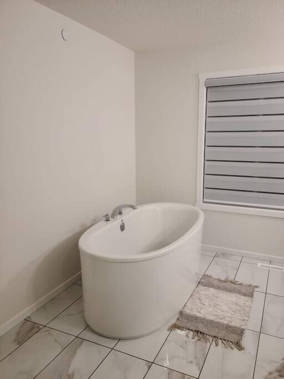 In-suite bathroom with a bathtub, large mirror direct access to bathroom