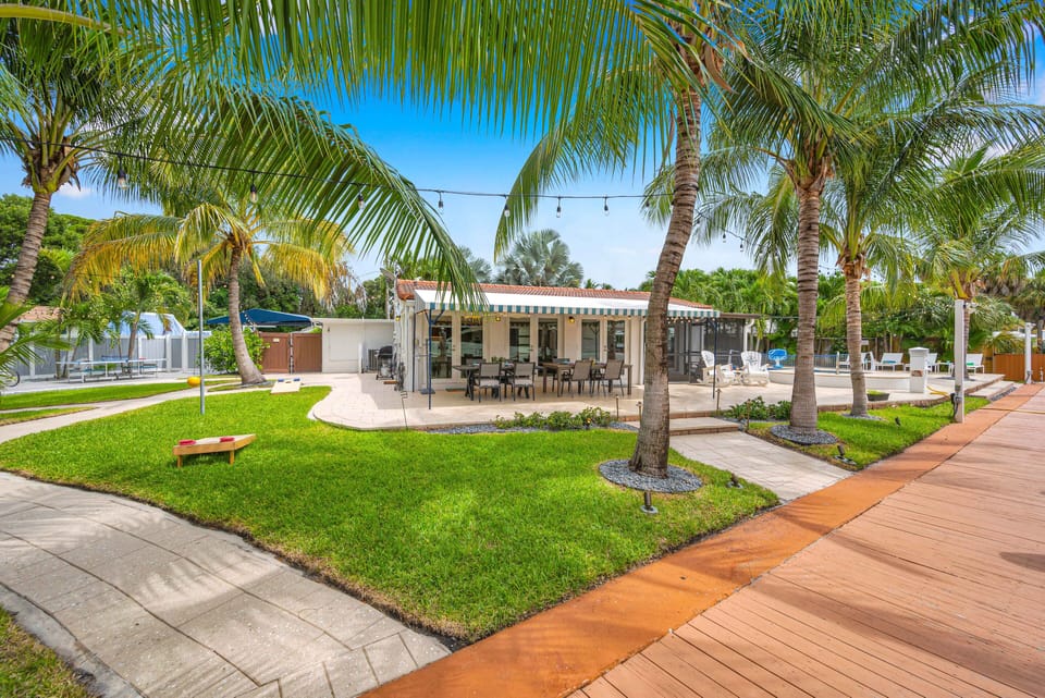 Relax in the greenery of the lush backyard featuring al fresco dinning, a grilling area, heated pool, outdoor games, and the waterfront!