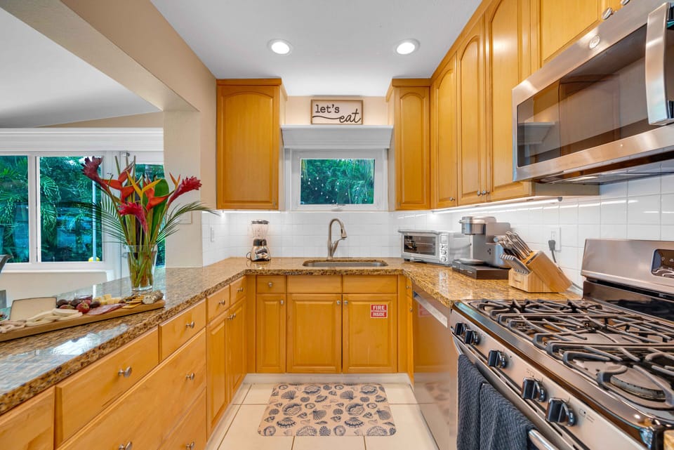 The kitchen / indoor dining room has a view of the pool and the waterfront.