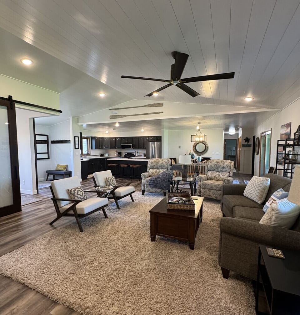 Open living room with plenty of comfortable seats and great sunset views