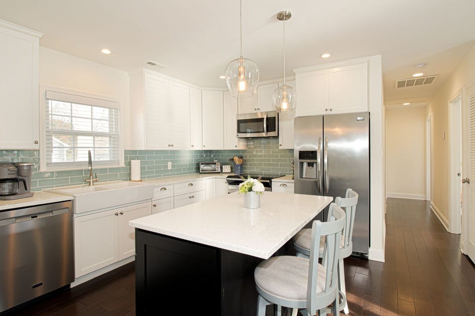 The updated kitchen is well-appointed with dishes, cookware, and appliances.
