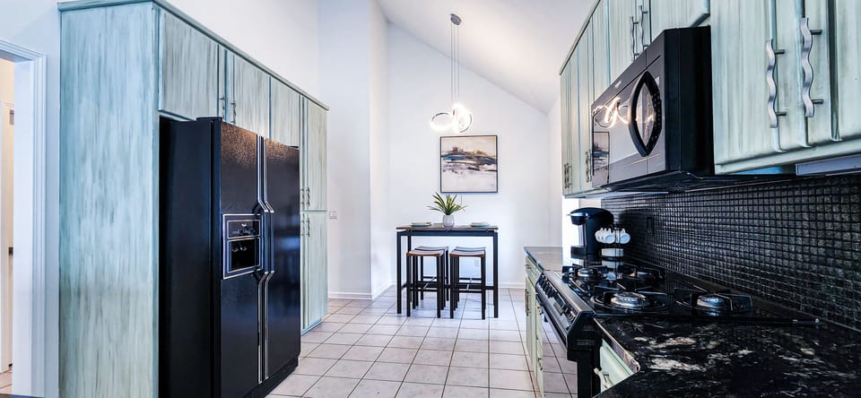 Fully stocked kitchen with flatware and essential appliances