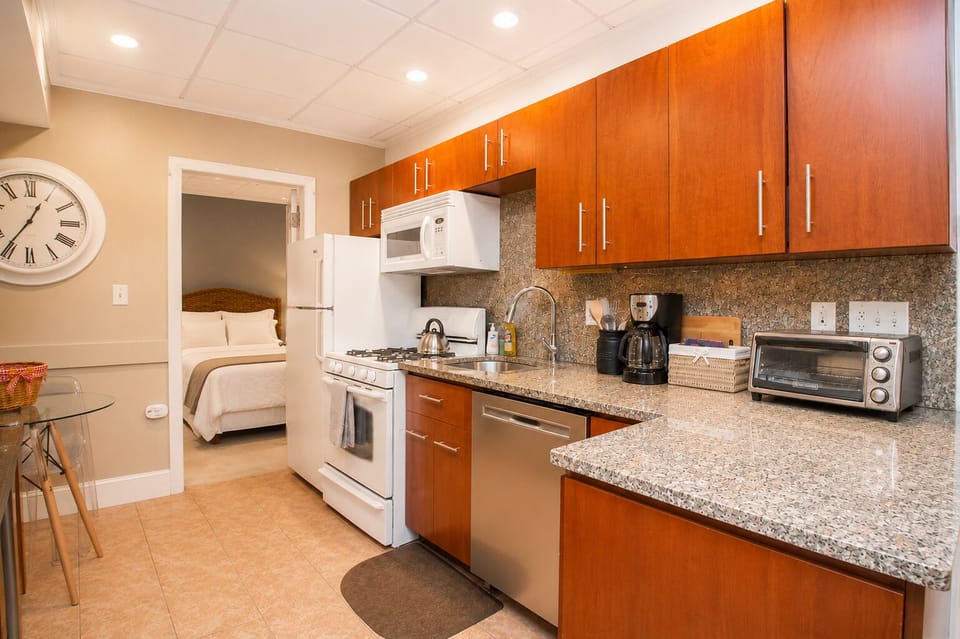 Modern kitchen with granite countertops, sleek wood cabinets