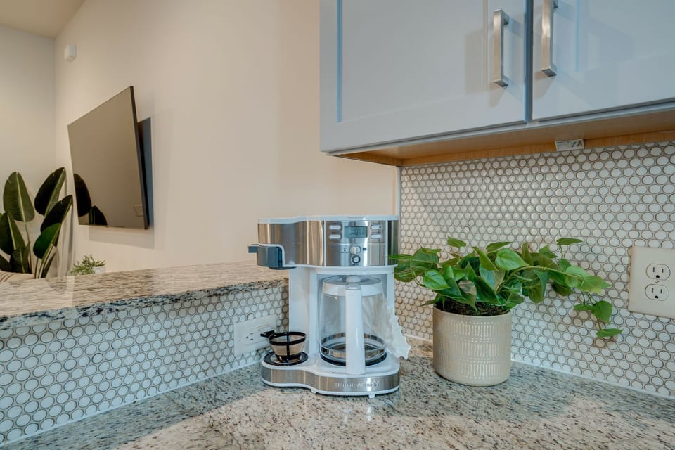Fully equipped kitchen with stainless steel appliances, breakfast bar seating, and fully stocked with your basic cooking essentials.