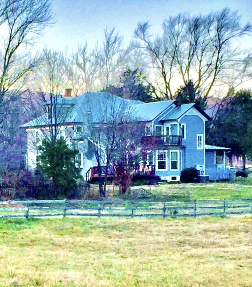 Back of our remodeled farm home, fenced pastures on all sides. 