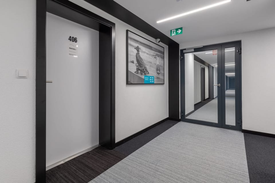 Bright and clean hallway with modern design elements and clear signage.
