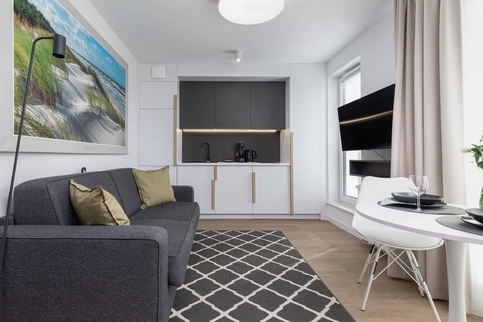 Comfortable seating area with stylish furniture and a bright window overlooking the outdoors.
