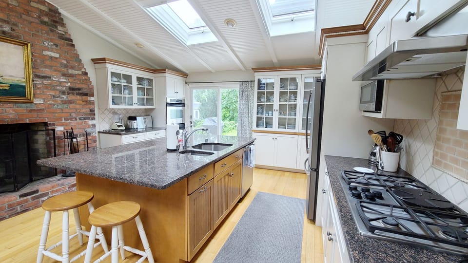 Kitchen has a large center island with counter seating