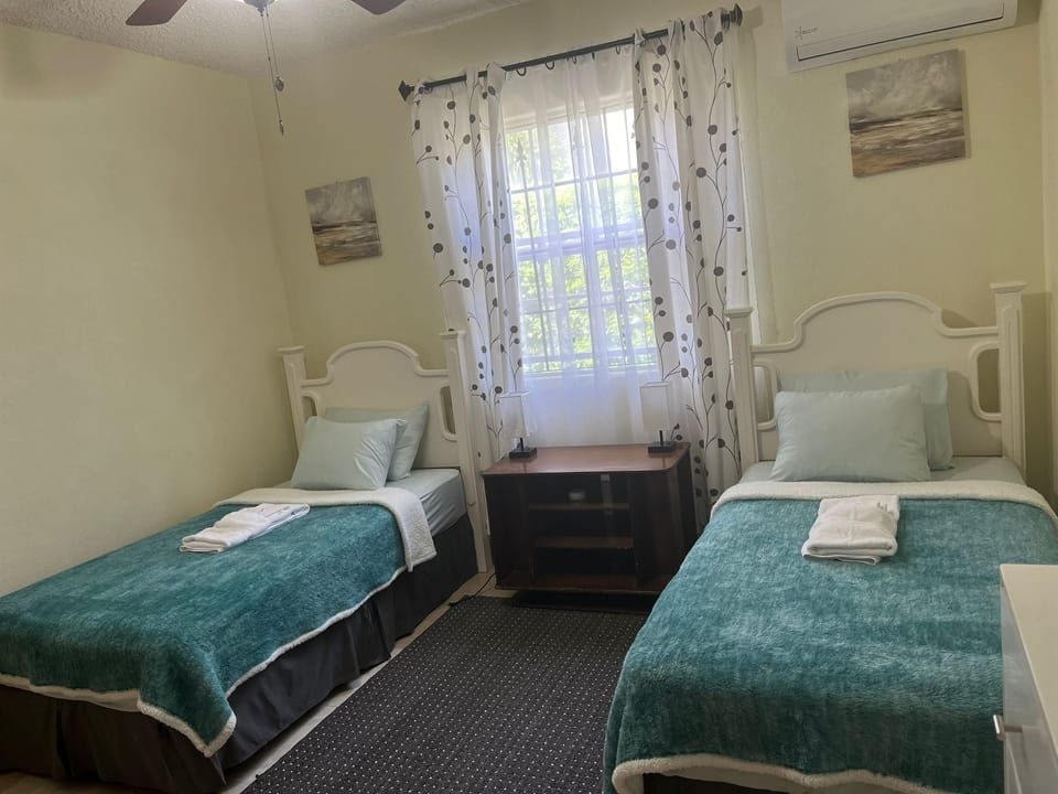 Bedroom 1 with twin beds and AC