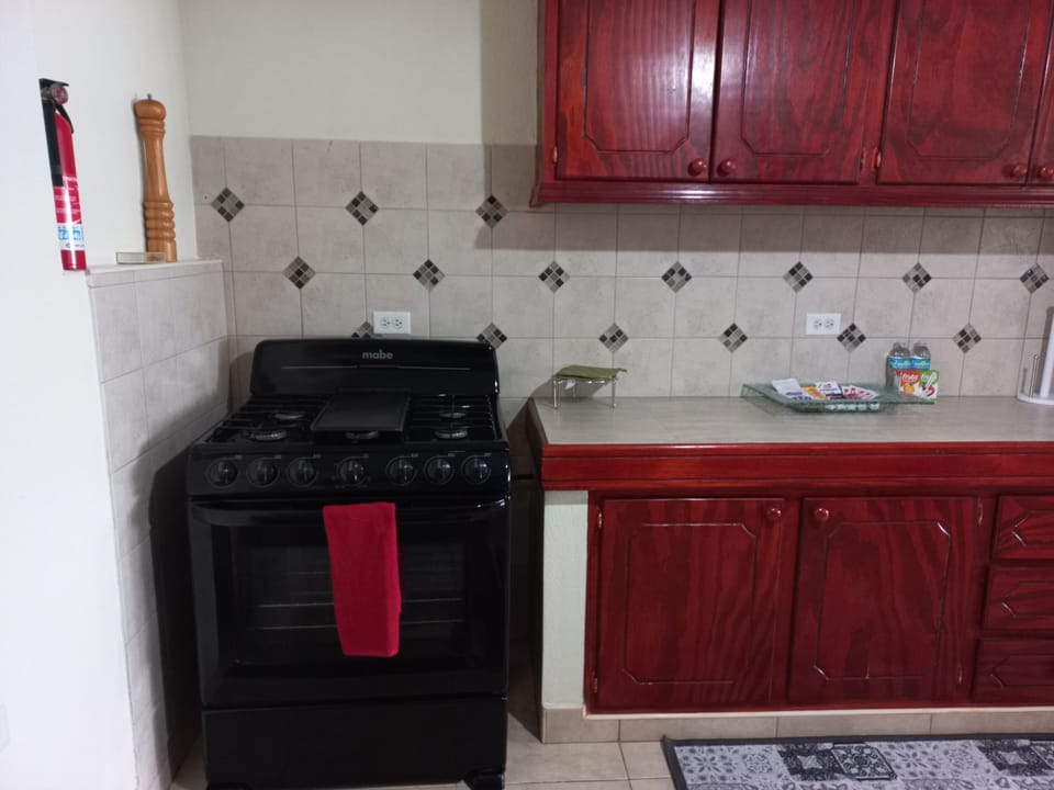 Kitchen fully equipped with a stove, microwave, electric kettle and toaster