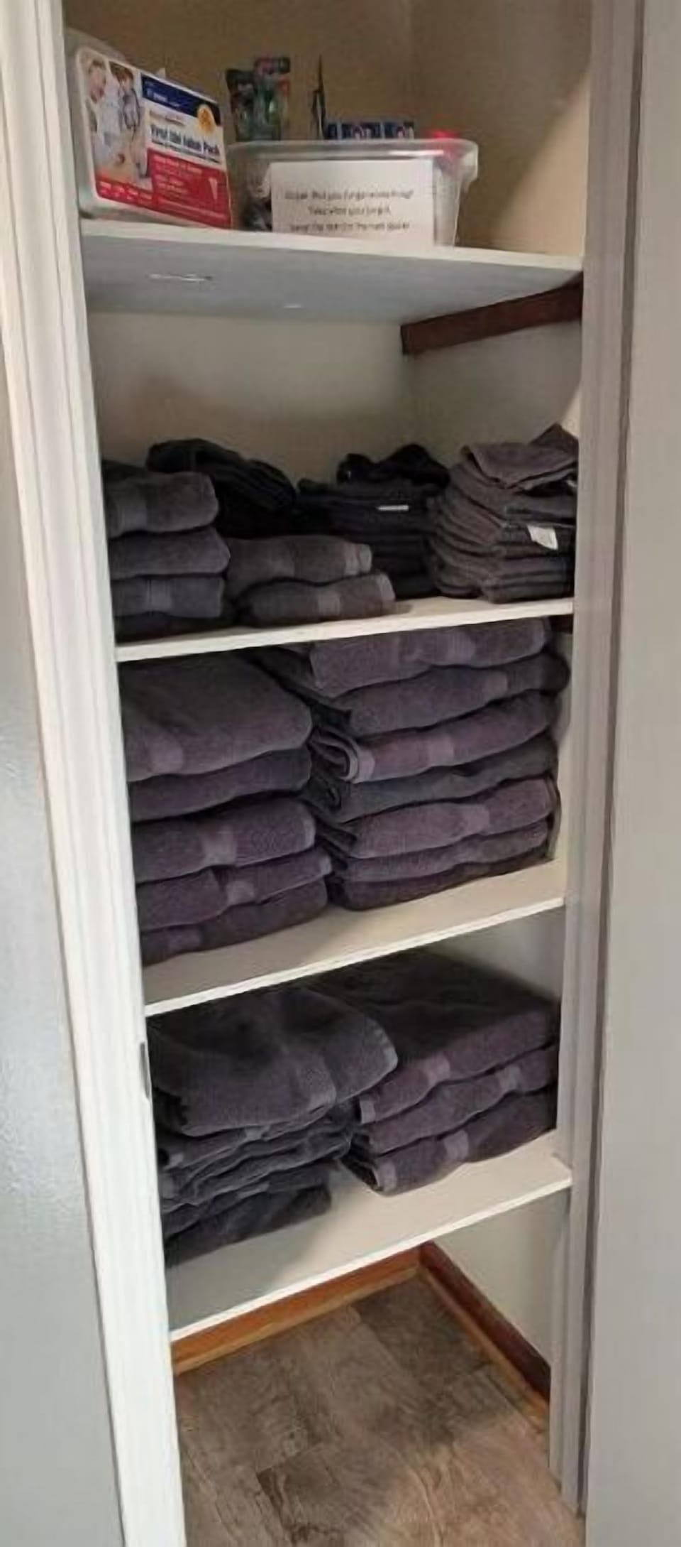 Hallway closet is filled with towels and washcloths.  The first aid kit is here.