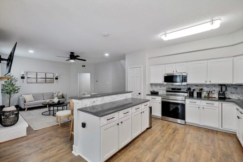 With updated cabinets, countertops, backsplash, and stainless-steel appliances, this spacious dream kitchen is only missing one thing – you!