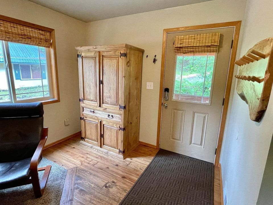 Entryway. Lots of hooks for coats. Cabinet with books and games.