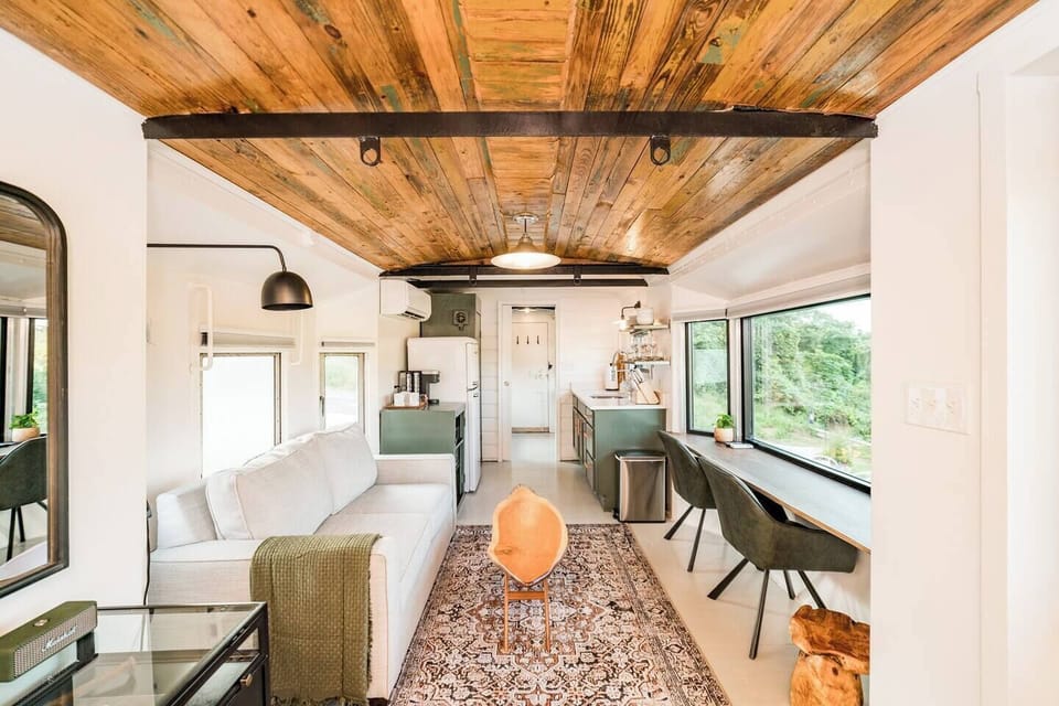 The living and dining areas can be found in the bay windows.