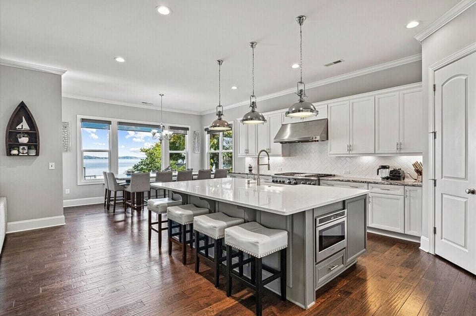Main level chef kitchen with dinning table for 14 and additional seating around island.