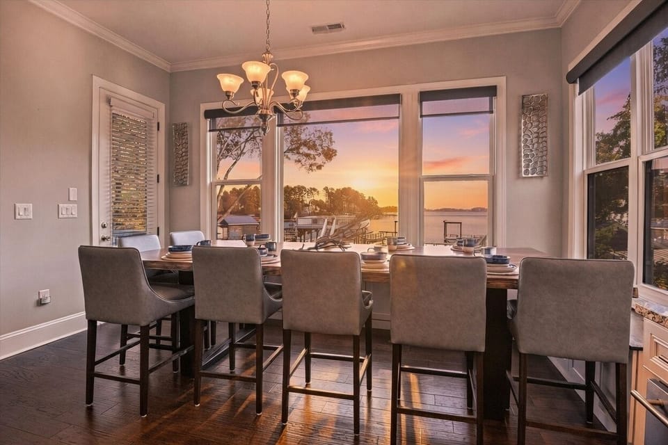 Main Level: Dinning table - Elegant dining area with a rustic wooden table, modern kitchen, and stylish decor. Perfect for family gatherings!