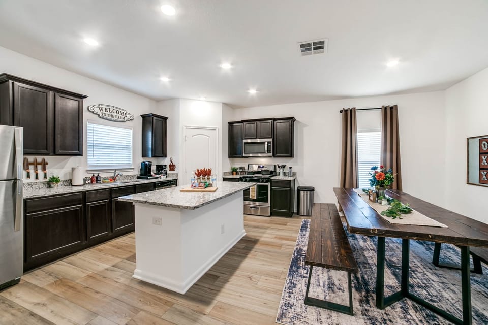 Spacious kitchen with gas stove and a large, handmade farmhouse table!