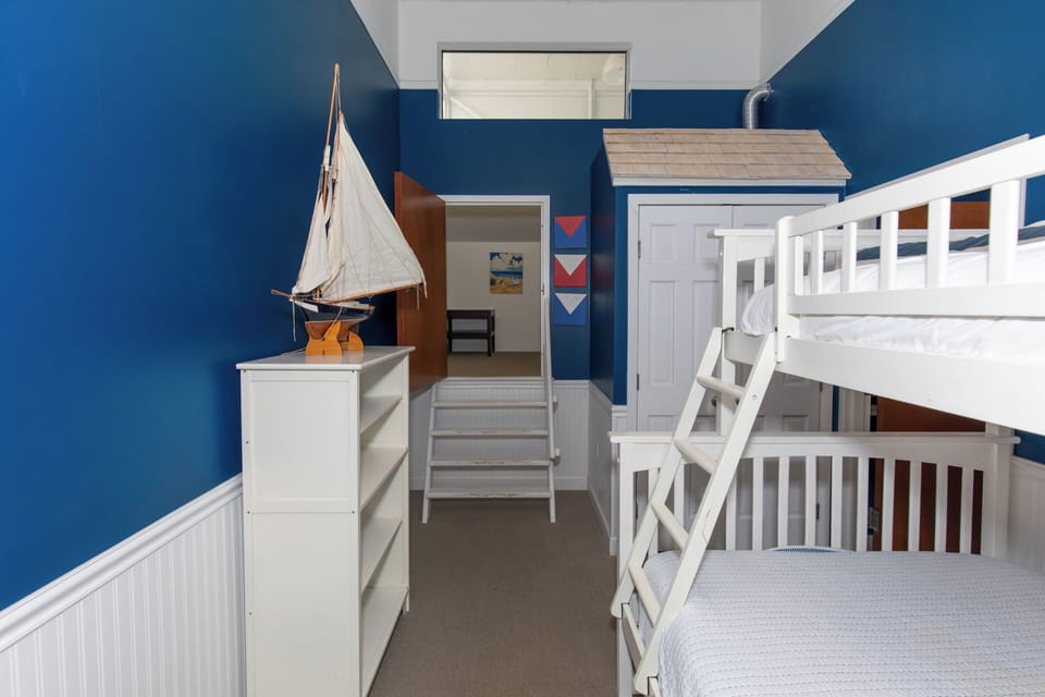 Your kids will love this nautical-themed bedroom with sturdy bunk beds and charming coastal decor that sparks adventure dreams.