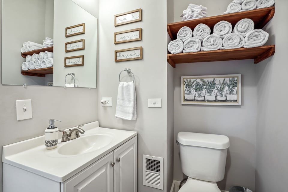 First floor full bathroom, with extra towels and washcloths and large mirror.
