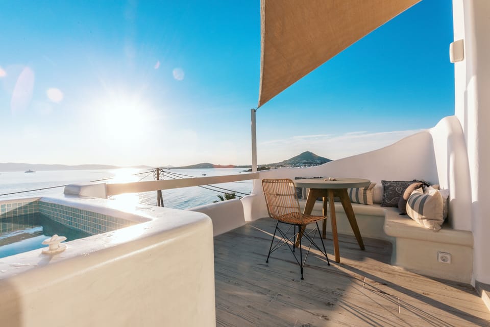 Private balcony of the flat with a hot tub, pouch chair and a panoramic sea view