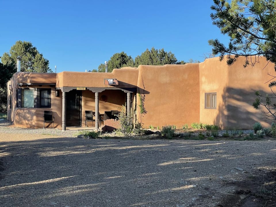 The Q house is a beautiful adobe home set in a beautiful secluded forest. 