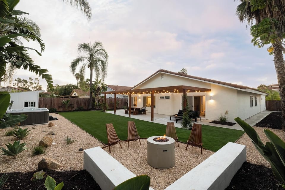 Private backyard with fire pit, hot tub, outdoor dining and lounge areas.