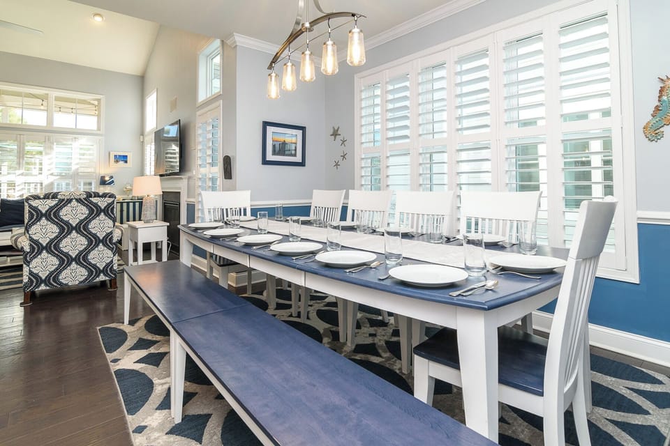 This large dining table includes seating for 12. Nearby breakfast bar seats 3.