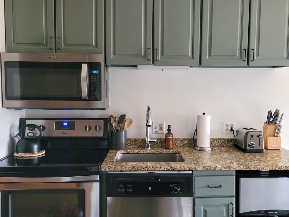 Fully equipped kitchen w/ a mini-fridge that has a separate freezer and fridge.