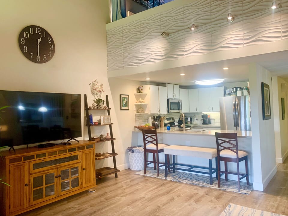 60" Smart Samsung TV in living.  Open breakfast bar.