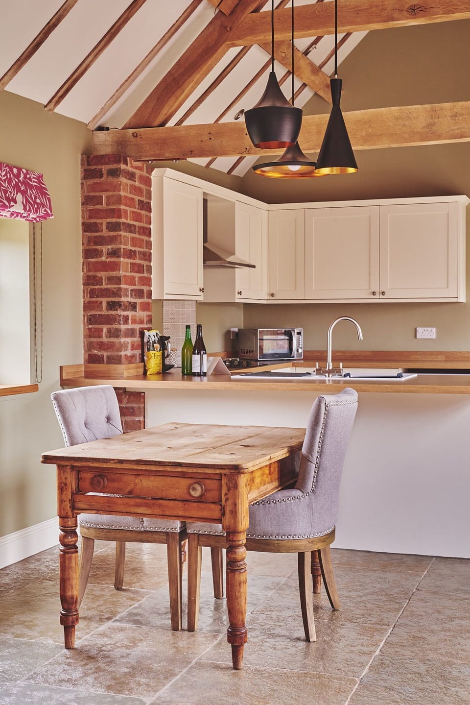 The two-seater dining table and chairs at The Dairy Barn, Worcestershire
