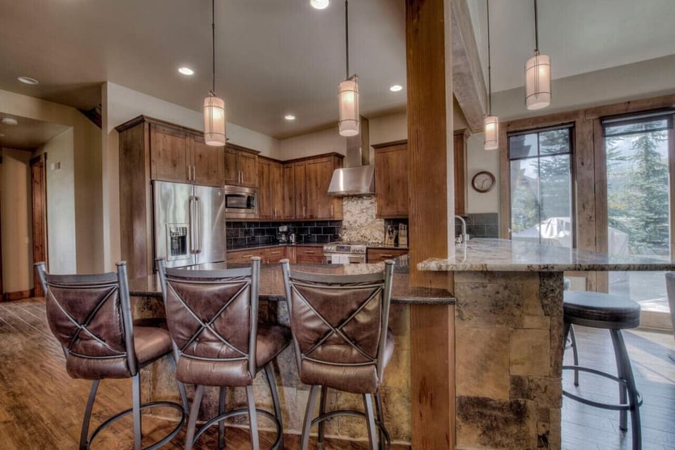 The fully equipped kitchen is stocked with pots and pans, dish-ware and glassware