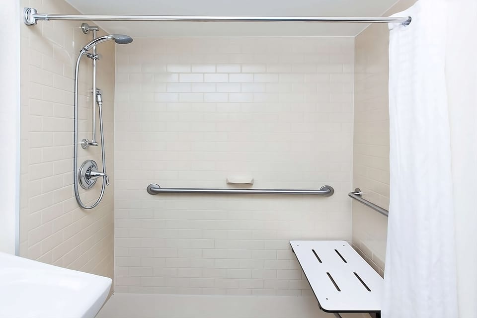 Rinse off comfortably with grab bars and convenient shower bench.
