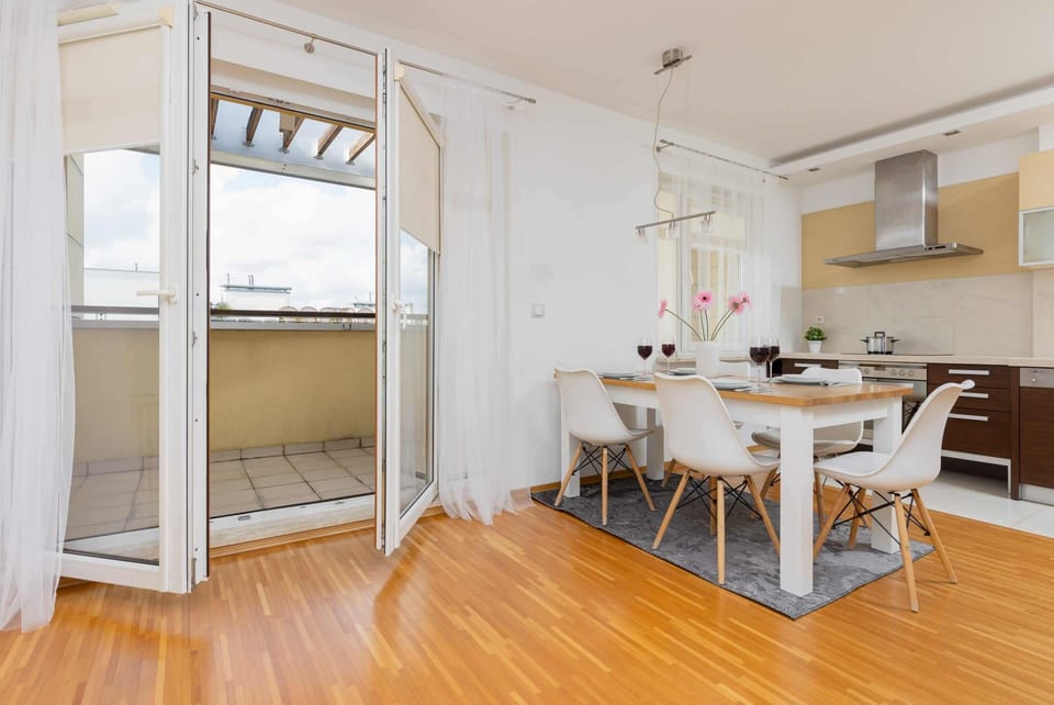 A light-filled dining area, complete with a modern table and chairs for your comfort.
